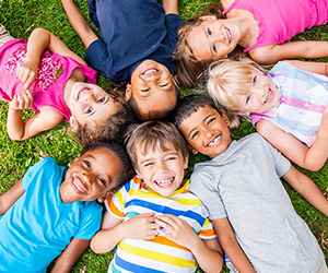 kids lying on grass