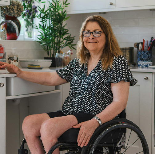 independent-living woman in wheelchair in kitchen